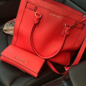 Michael kors red bag with matching wallet.